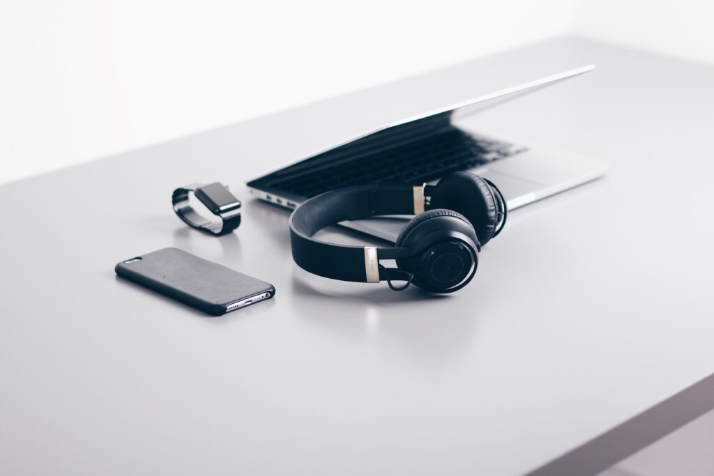 MacBook Pro, iPhone, Apple Watch and headphones lying on desk